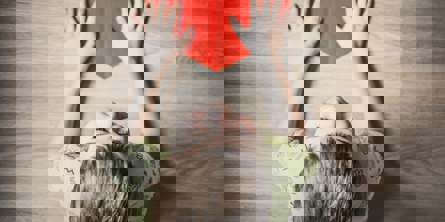 Child with red paper heart